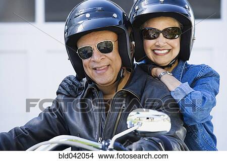 Picture - Senior African American couple on motorcycle. Fotosearch