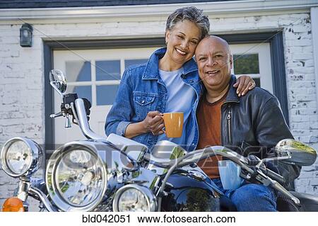 Stock Image - Senior African American couple on motorcycle. Fotosearch