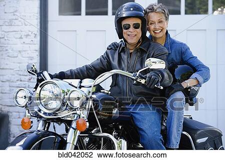 Stock Image - Senior African American couple on motorcycle. Fotosearch