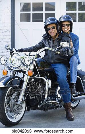 Stock Image - Senior African American couple on motorcycle. Fotosearch