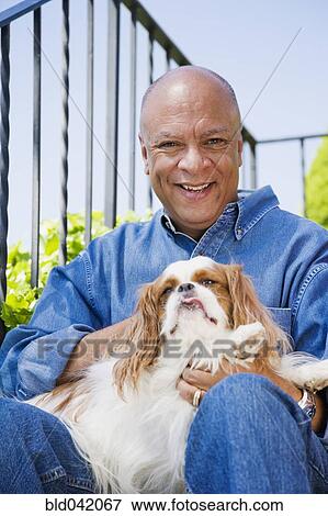 Senior African American man hugging dog View Large Photo Image Stock Photo - Senior African American man hugging dog. Fotosearch