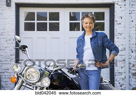 Senior African American woman next to motorcycle View Large Photo Image Stock Photography - Senior African American woman next to motorcycle. Fotosearch