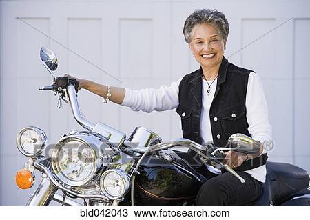 Senior African American woman sitting on motorcycle View Large Photo Image Stock Image - Senior African American woman sitting on motorcycle. Fotosearch