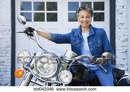 Senior African American woman sitting on motorcycle View Large Photo Image Stock Photograph - Senior African American woman sitting on motorcycle. Fotosearch