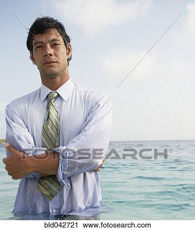 Stock Image - South American businessman in water. Fotosearch