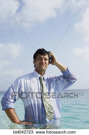 Stock Image - South American businessman in water. Fotosearch