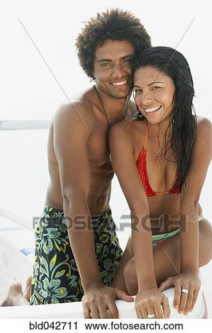 Stock Image - South American couple at beach. Fotosearch