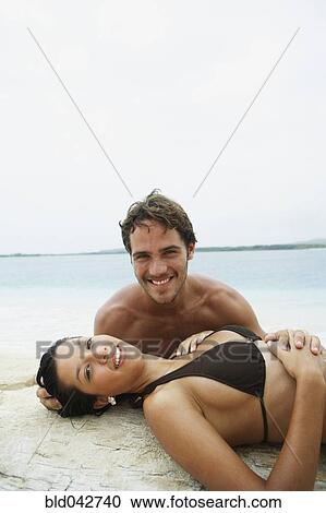 Stock Image - South American couple at beach. Fotosearch