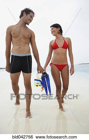 South American couple carrying snorkeling gear View Large Photo Image Stock Photograph - South American couple carrying snorkeling gear. Fotosearch