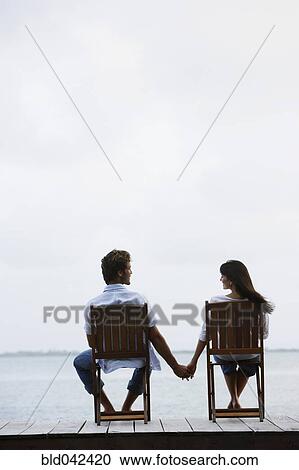 South American couple holding hands on dock View Large Photo Image Stock Image - South American couple holding hands on dock. Fotosearch