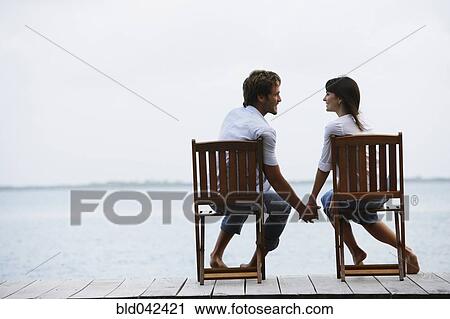 South American couple holding hands on dock View Large Photo Image Stock Image - South American couple holding hands on dock. Fotosearch