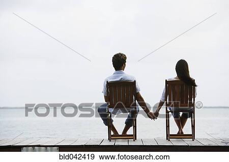 South American couple holding hands on dock View Large Photo Image Stock Photo - South American couple holding hands on dock. Fotosearch