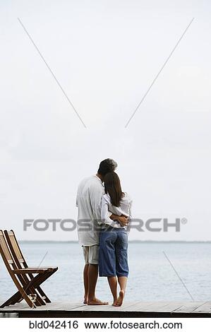 South American couple hugging on dock View Large Photo Image Stock Photograph - South American couple hugging on dock. Fotosearch