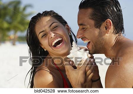 South American couple laughing at beach View Large Photo Image Stock Photo - South American couple laughing at beach. Fotosearch