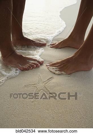 South American couple next to starfish imprint View Large Photo Image Picture - South American couple next to starfish imprint. Fotosearch