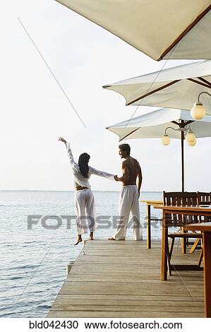 Stock Image - South American couple on dock. Fotosearch
