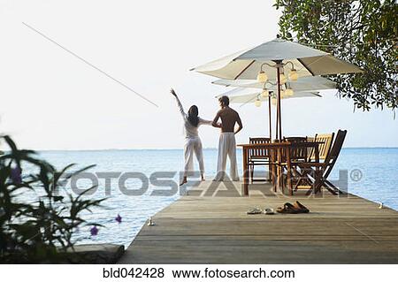 Stock Photo - South American couple on dock. Fotosearch