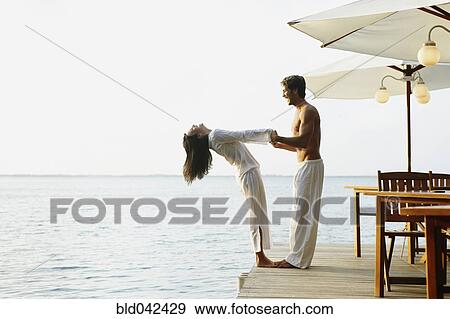 Stock Photo - South American couple on dock. Fotosearch