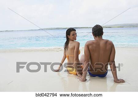 South American couple sitting on beach View Large Photo Image Picture - South American couple sitting on beach. Fotosearch