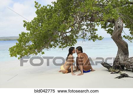 South American couple sitting on beach View Large Photo Image Stock Photography - South American couple sitting on beach. Fotosearch