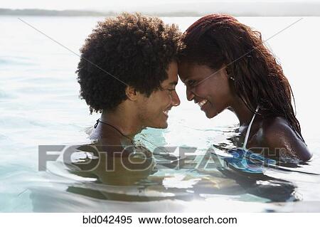 Stock Photography - South American couple smiling at each other. Fotosearch