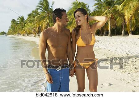 South American couple walking on beach View Large Photo Image Stock Photo - South American couple walking on beach. Fotosearch