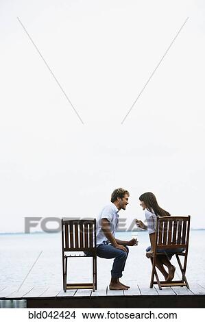 Picture - South American couple with wine on dock. Fotosearch