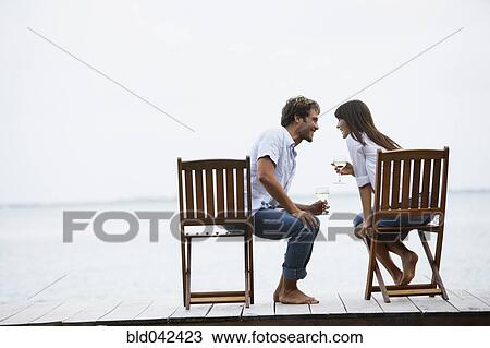 South American couple with wine on dock View Large Photo Image Stock Image - South American couple with wine on dock. Fotosearch