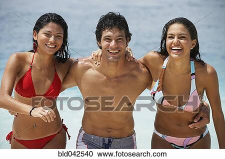 Stock Image - South American friends at beach. Fotosearch