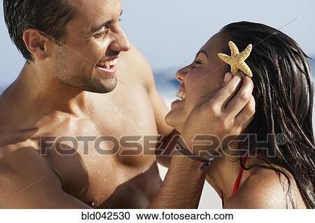 South American man holding starfish in girlfriend's hair View Large Photo Image Stock Image - South American man holding starfish in girlfriend's hair. Fotosearch