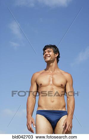 Stock Image - South American man in bathing suit. Fotosearch