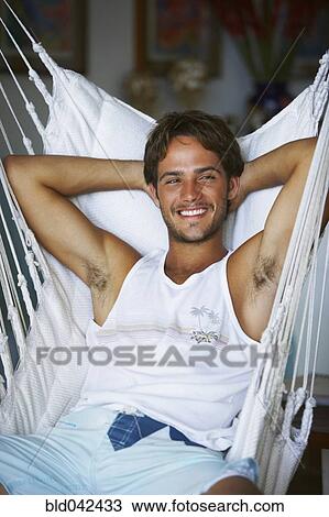 Stock Image - South American man in hammock. Fotosearch