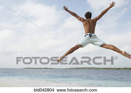 South American man jumping on beach View Large Photo Image Picture - South American man jumping on beach. Fotosearch