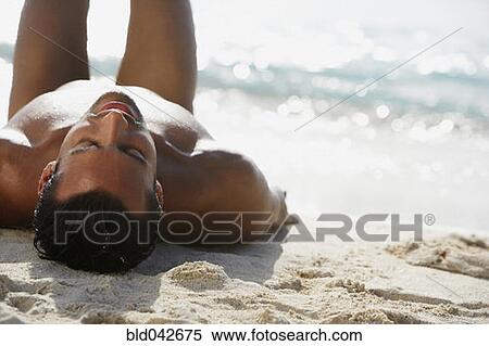South American man laying on beach View Large Photo Image Stock Photography - South American man laying on beach. Fotosearch