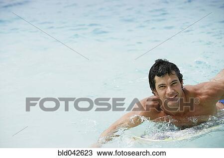 South American man on surfboard View Large Photo Image Stock Image - South American man on surfboard. Fotosearch
