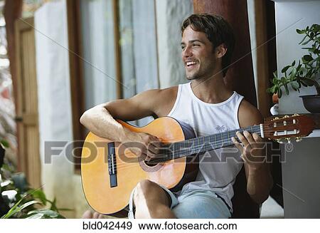 Stock Photo - South American man playing guitar. Fotosearch