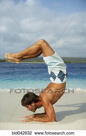 Stock Image - South American man practicing yoga. Fotosearch
