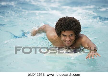 Stock Image - South American man swimming. Fotosearch