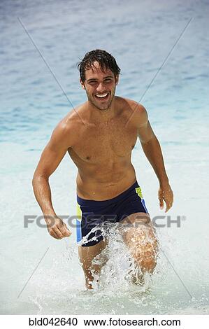 South American man walking in water View Large Photo Image Stock Image - South American man walking in water. Fotosearch
