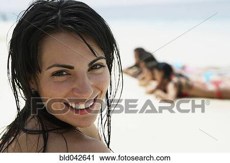 Stock Image - South American woman at beach. Fotosearch
