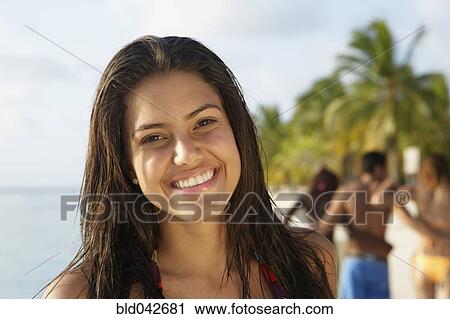 Stock Image - South American woman at beach. Fotosearch