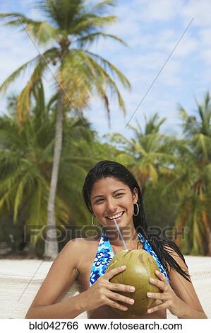 South American woman drinking from coconut View Large Photo Image Stock Photograph - South American woman drinking from coconut. Fotosearch