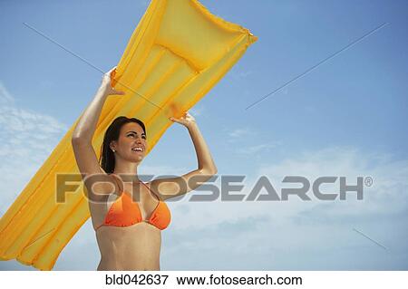 South American woman holding raft View Large Photo Image Stock Photo - South American woman holding raft. Fotosearch
