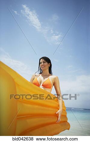Stock Photo - South American woman holding raft. Fotosearch
