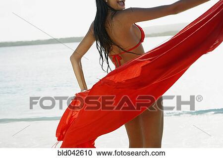 South American woman holding sarong at beach View Large Photo Image Stock Image - South American woman holding sarong at beach. Fotosearch