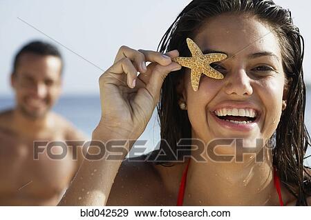 South American woman holding starfish over eye View Large Photo Image Stock Photo - South American woman holding starfish over eye. Fotosearch