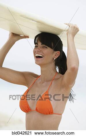South American woman holding surfboard View Large Photo Image Stock Image - South American woman holding surfboard. Fotosearch