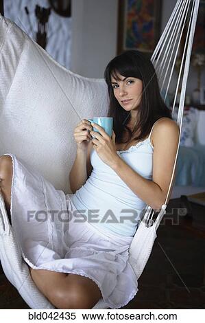 Stock Photography - South American woman in hammock. Fotosearch