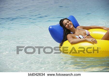 Picture - South American woman in raft. Fotosearch