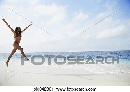 South American woman jumping on beach View Large Photo Image Stock Image - South American woman jumping on beach. Fotosearch